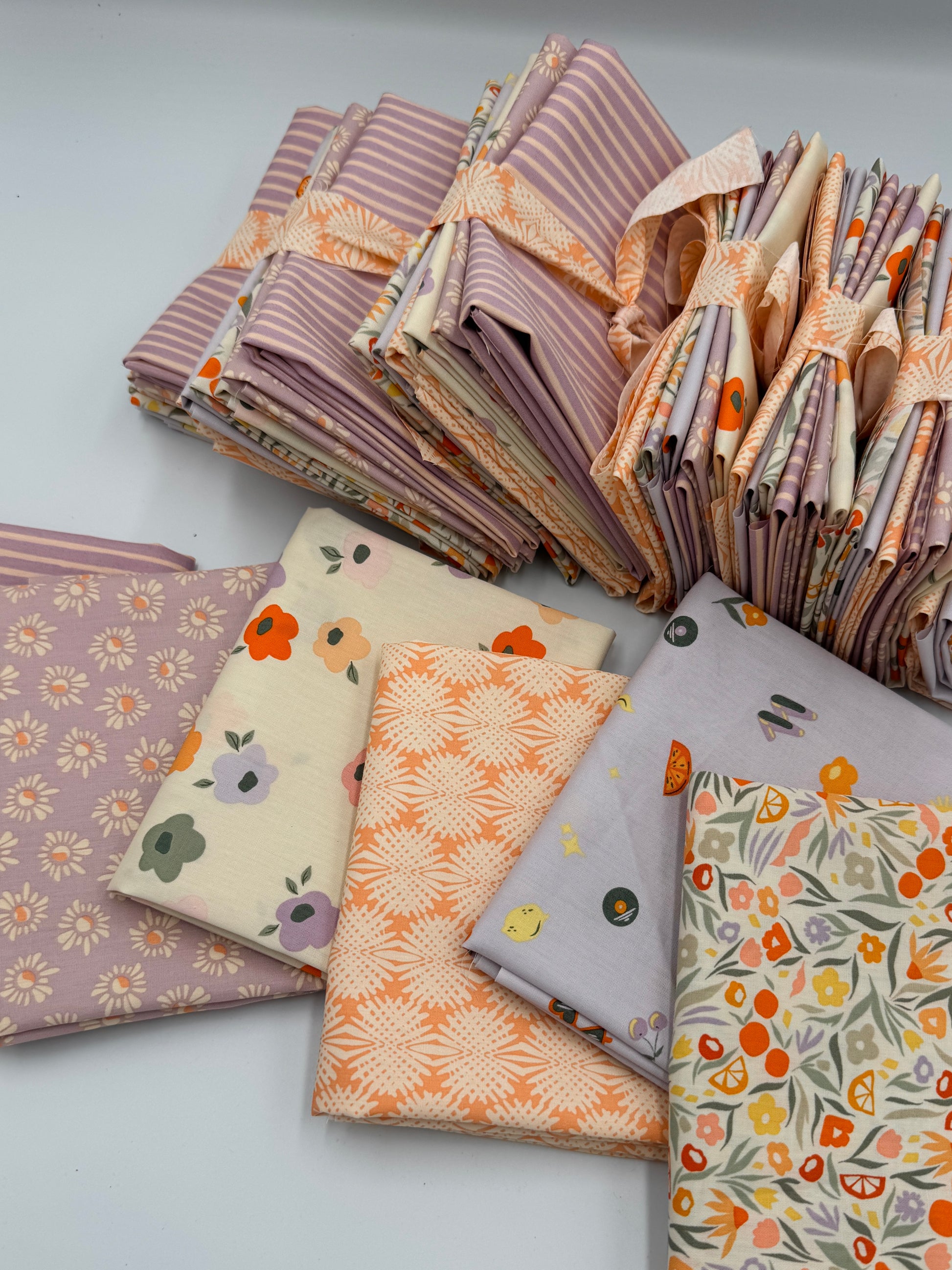 Collection of patterned fabric swatches on a light gray background
