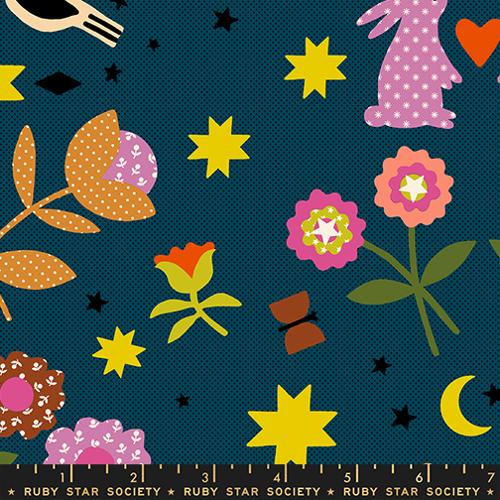 Colorful fabric pattern with flowers, stars, and other shapes on a blue background.