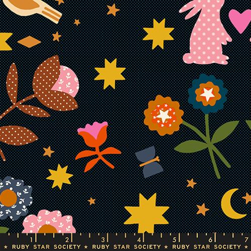 Colorful fabric pattern with flowers, stars, and other shapes on a black background, featuring the Ruby Star Society label.