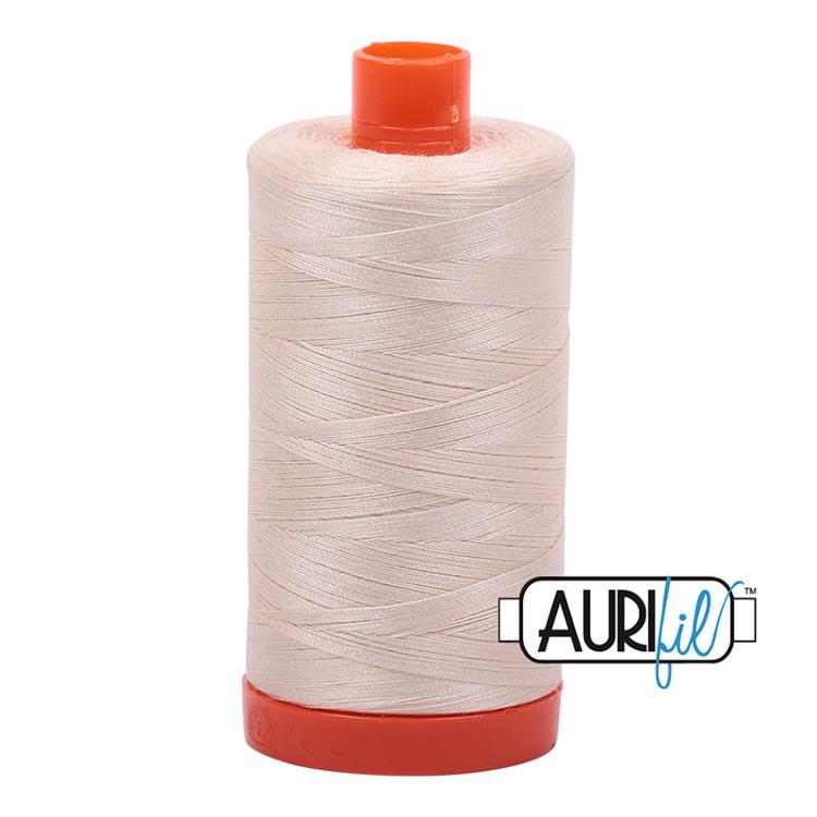 Spool of beige thread with red cap on a white background, featuring the Aurifil logo.