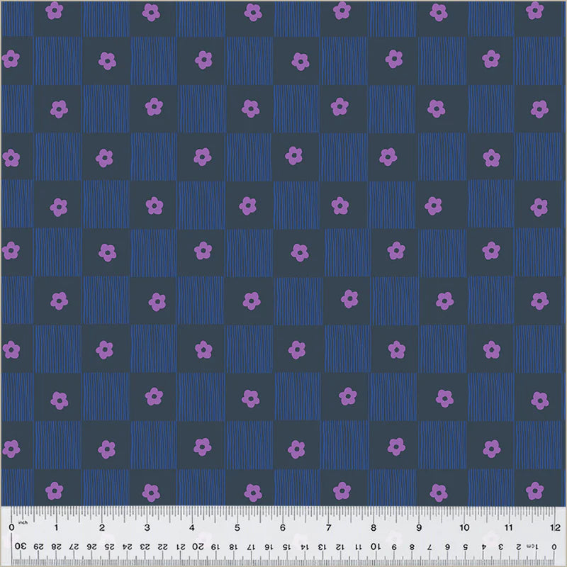 Checkered pattern with small pink flowers on a blue background, measured with a ruler at the bottom.