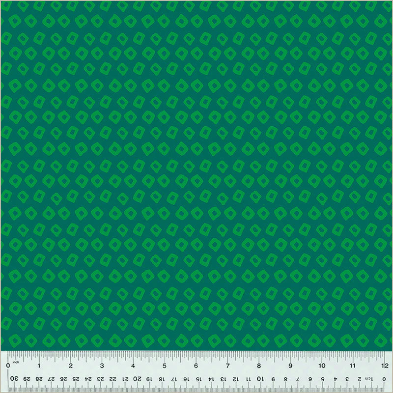 Green geometric patterned fabric with a ruler at the bottom